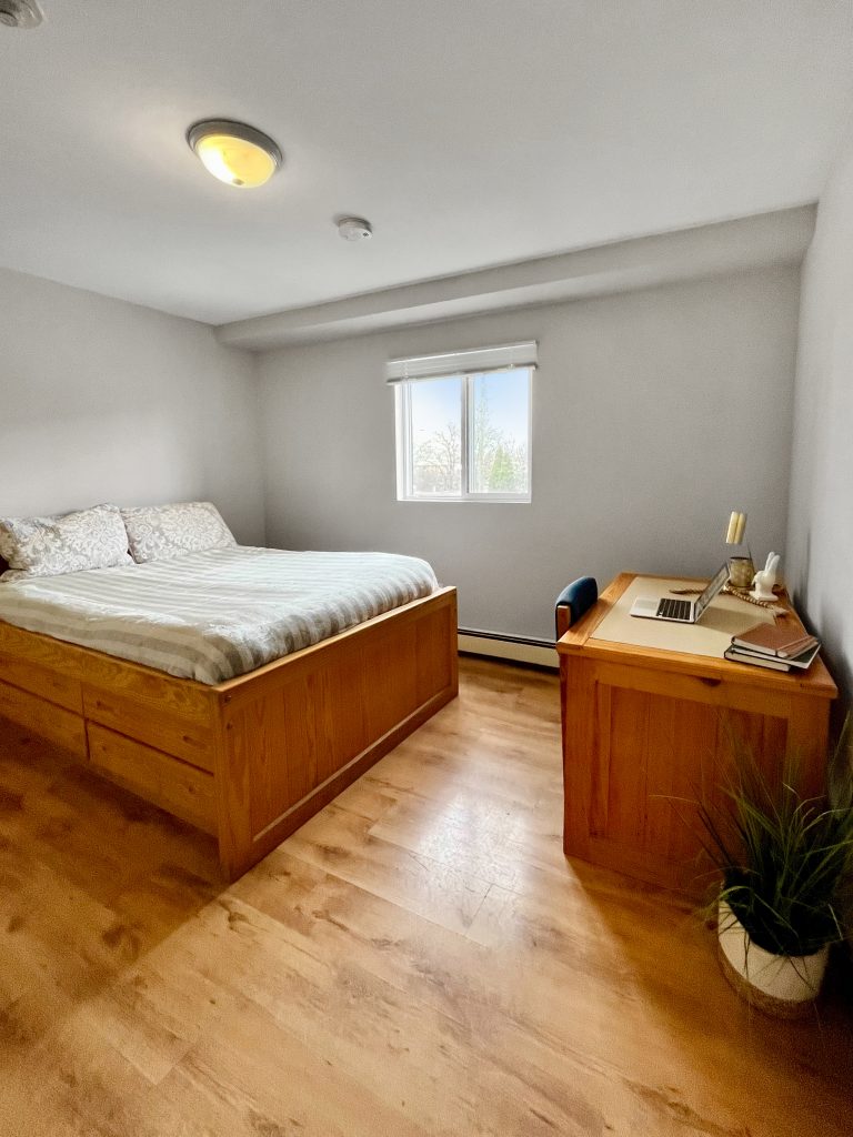 standard bedroom with bed and desk